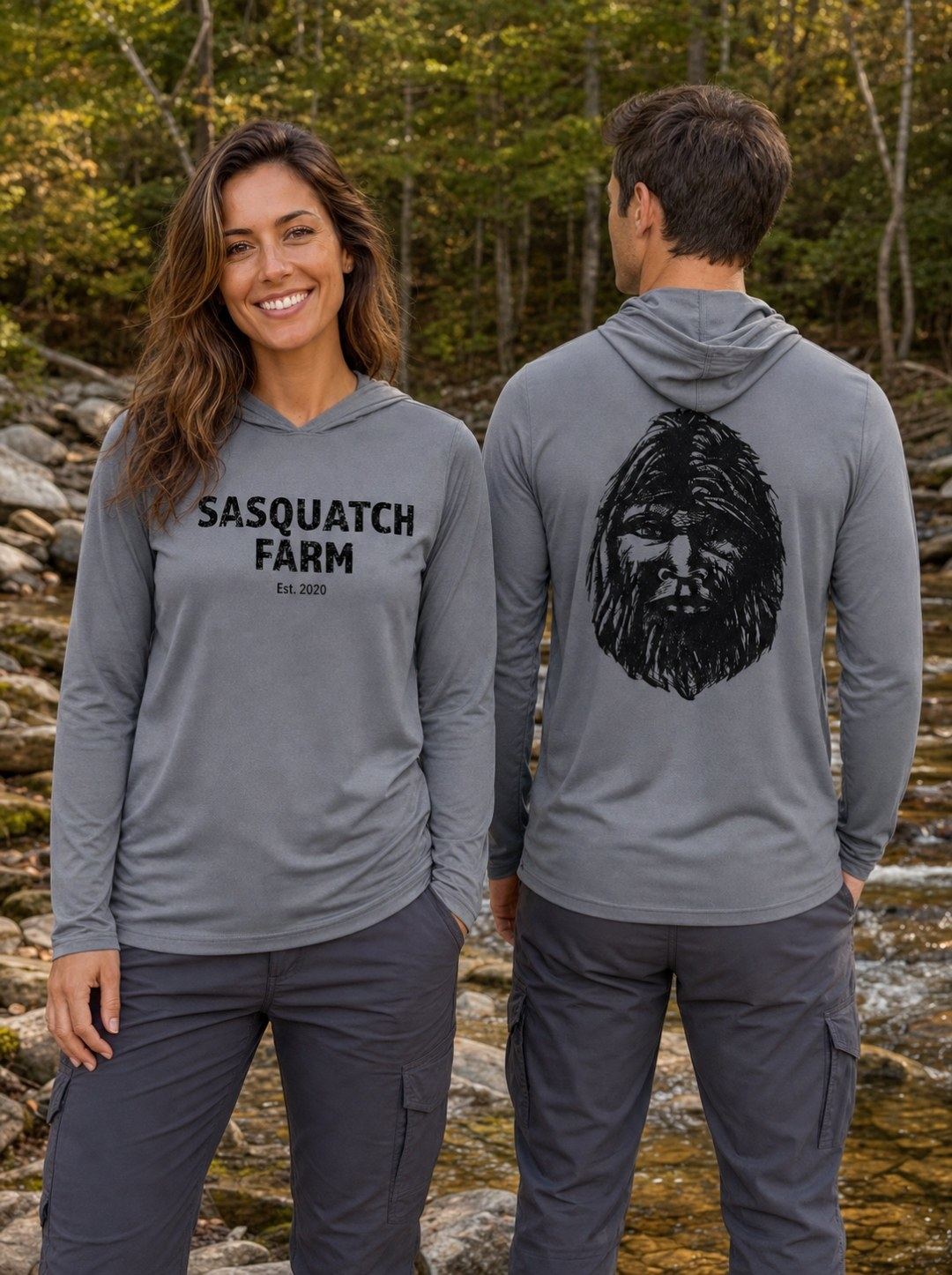 Two people wearing graphite Team 365 lightweight Squatchy Style hoodies outdoors